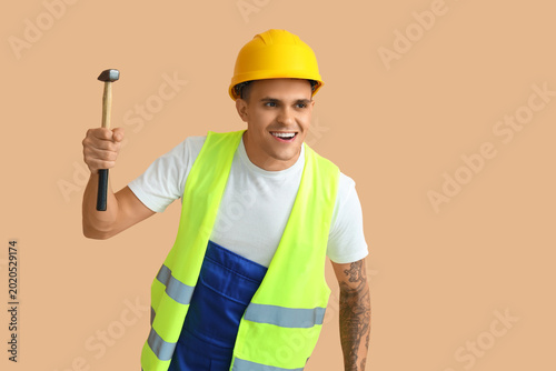 Male worker with hammer on ...