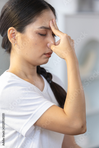 Schilderij op canvas Calm asian woman practicing alternate nostril breathing, pranayama yoga exercise for stress relief