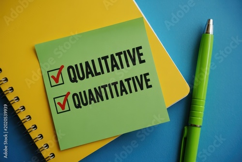 Qualitative and quantitative research methodology concept on sticky note with notebook and pen