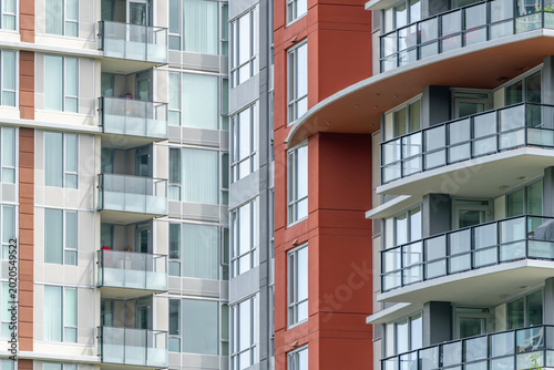 Modern apartment building facades with balconies and glass windows
