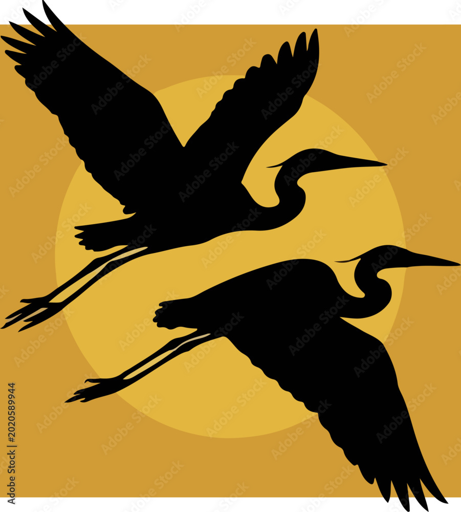 Fototapeta premium Silhouette of two majestic herons flying against a golden sun background.