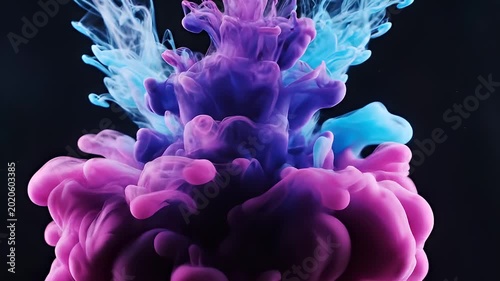 Blue and Pink Ink Mixing and Swirling in Water on Black Background