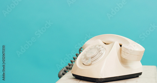 Fotografie Studio, space and retro telephone for communication, connection or contact on blue background mockup