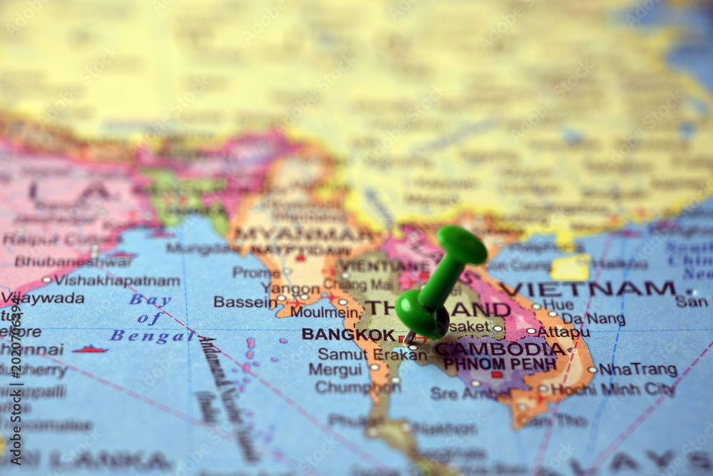 Obraz premium Green Push Pin Highlighting Bangkok on Paper World Map Macro Close Up with Soft Blur