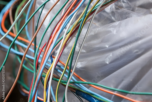 Fotografi Colorful cable wire tangle creates messy chaos of electricity connections next t