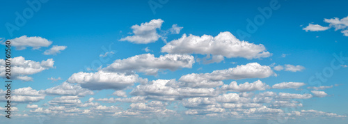 Clouds move in the blue sky. Tropical clouds at day time  white and blue. Transparent clouds layers. A clear blue sky adorned with fluffy white clouds. Calm serene cloud background.