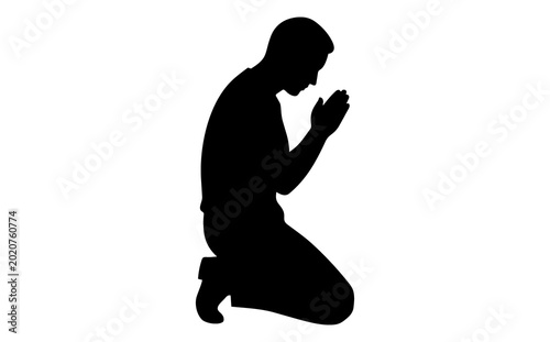 Silhouette of a person kneeling and praying with hands clasped in devotion spiritual reflection and meditation set against a plain background emphasizing faith and serenity
