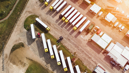Bild auf Leinwand Logistic center with parked semi-trucks