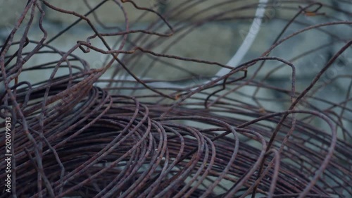 Rusty tangled steel wire at a construction site, industrial background.