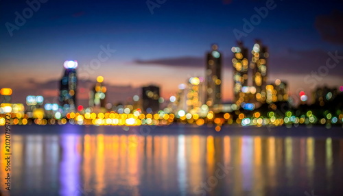 Blurred Cityscape Lights Reflecting on Lake Water at Night