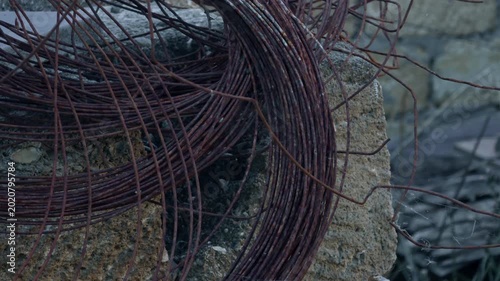 Rusty tangled steel wire at a construction site, industrial background.