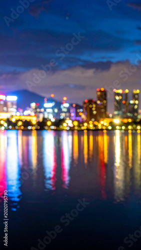 Blurred Cityscape Lights Reflecting on Lake Water at Night