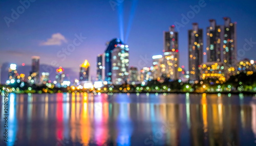 Blurred Cityscape Lights Reflecting on Lake Water at Night