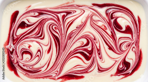 Macro texture of smooth white chocolate and raspberry syrup marbling