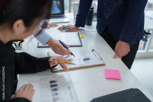 Business team analyzing financial data on documents