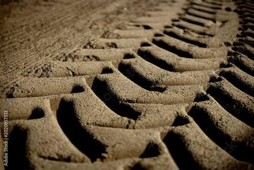 tractor tire tracks in the sand