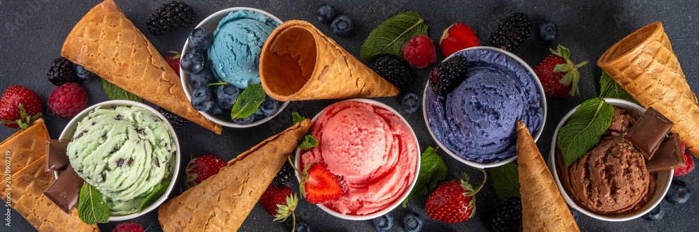 Fototapeta premium Colorful bright ice cream on bowls, with waffle cones