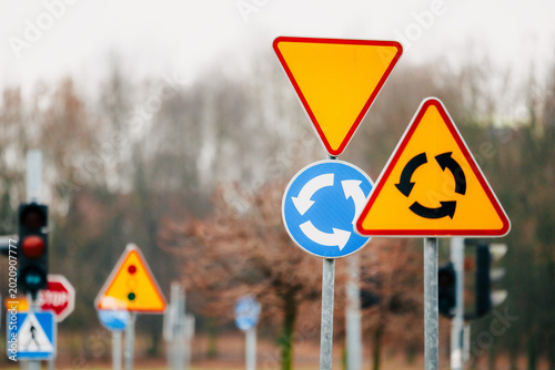 Road signs near roundabout intersection
