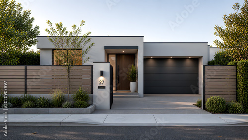 Modern suburban house with sleek garage door and contemporary landscaping