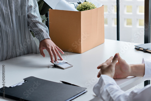 Resignation concept.Businesswoman packing Stuff with cardboard box for quit a job