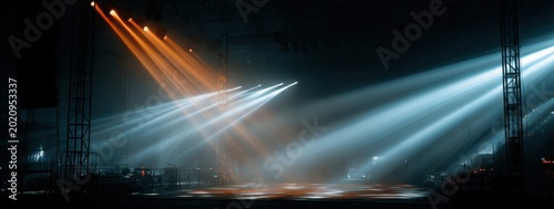 Stage Lights Illuminating a Dark Concert Venue with Dramatic Beams.
