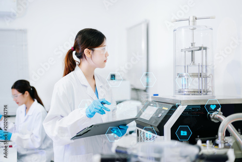 Fotografía Medical scientists performing biotechnology laboratory research with DNA molecul