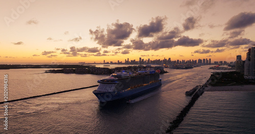 Cruise ship sailing out of miami harbor at sunset