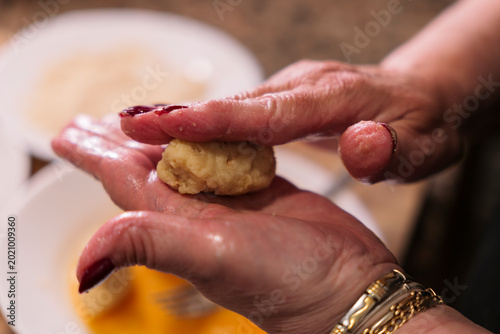 Bild auf Leinwand Spanish Croquettes Preparation Dipped in Beaten Egg Before Breading