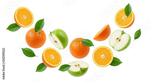 Fresh oranges and green apple slices floating with green leaves on a solid black background