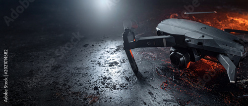 Modern quadcopter drone on textured black metallic ground. Cinematic spotlight with warm orange accent lighting. High resolution 3D render for technology, aerospace and surveillance industry themes.