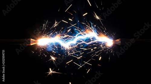 Close-up of Electric Spark Discharge with Bright Flashes and Sparks in Darkness.