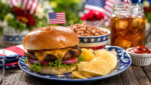 Burger with american flag outdoor summer picnic table setting