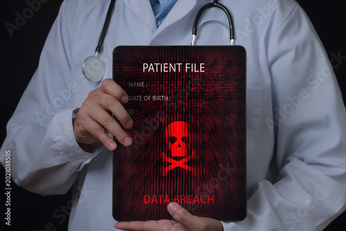 Billede på lærred Serious doctor holding tablet showing alarming medical data breach of patient fi