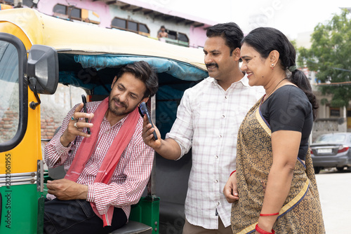 Konstfotografi Indian couple making an online payment using app - payment bar code, bar code scanner, transportation, Delhi auto fare