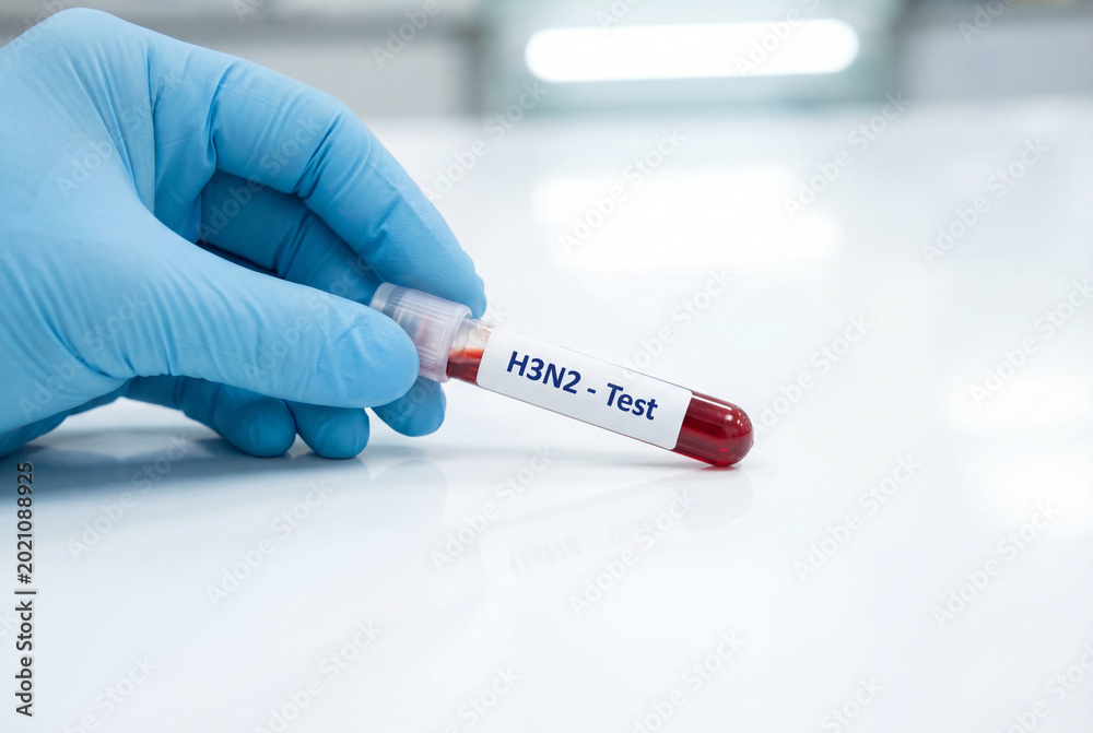 Obraz premium Gloved hand holds test tube with red blood sample for h3n2 virus test