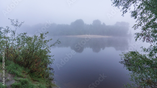 Obraz na płótnie a misty river landscape at dawn