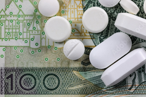 A few medical pills on a one-hundred-zloty banknote from Poland