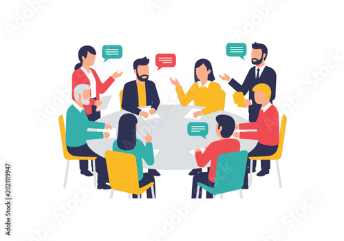 A group of diverse people are sitting around a table discussing and gesturing in a meeting