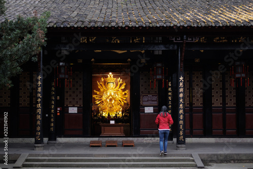 Bild auf Leinwand Person approaching golden avalokiteshvara statue, chengdu, china