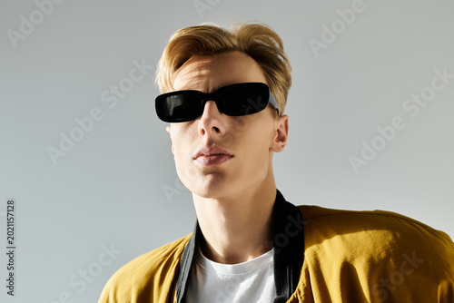 Tableau sur toile Stylish young man showcasing fashion trends with confidence and charisma in mode