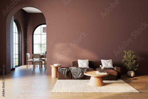 Quadro su tela Modern living room interior with brown textured wall, sofa, wood coffee tables, arched doorway and large windows in a warm neutral home setting