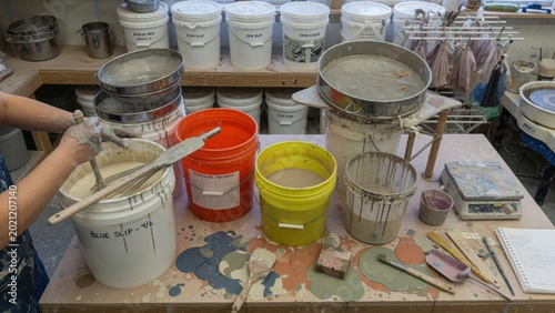 Creative Pottery Studio with Colorful Slips and Tools