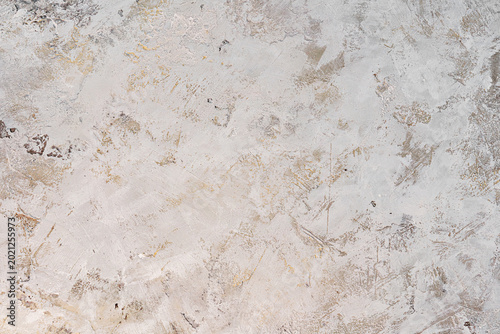 Light grey and beige textured background with plaster brush strokes.