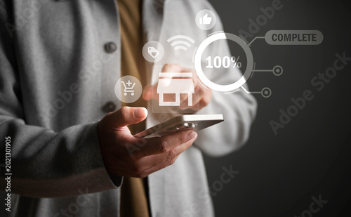 Businessman pressing virtual button of smart phone for shopping online 