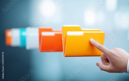 Human Hand Selecting Bright Yellow Folder Icon from Colorful Set