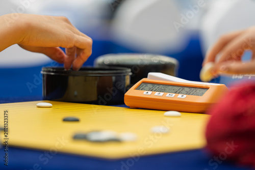Close-up of Go player placing stone during match