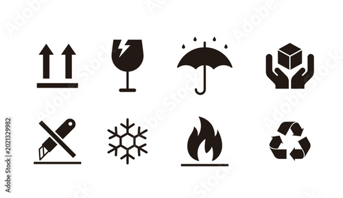 Set of packaging and shipping symbols for cargo handling. Black icons including fragile, keep dry, this side up, flammable, and recycle signs for warehouse logistics and product packaging design.