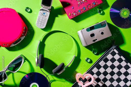 Top view of vintage gadgets and fashion accessories for 2000s nostalgia
