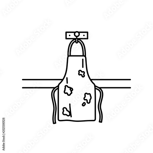 Stained apron hanging on a hook in a minimalist kitchen  