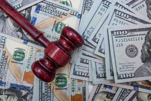 Foto Close up of Gavel on Hundred Dollar Bills for Financial Crime Investigation and